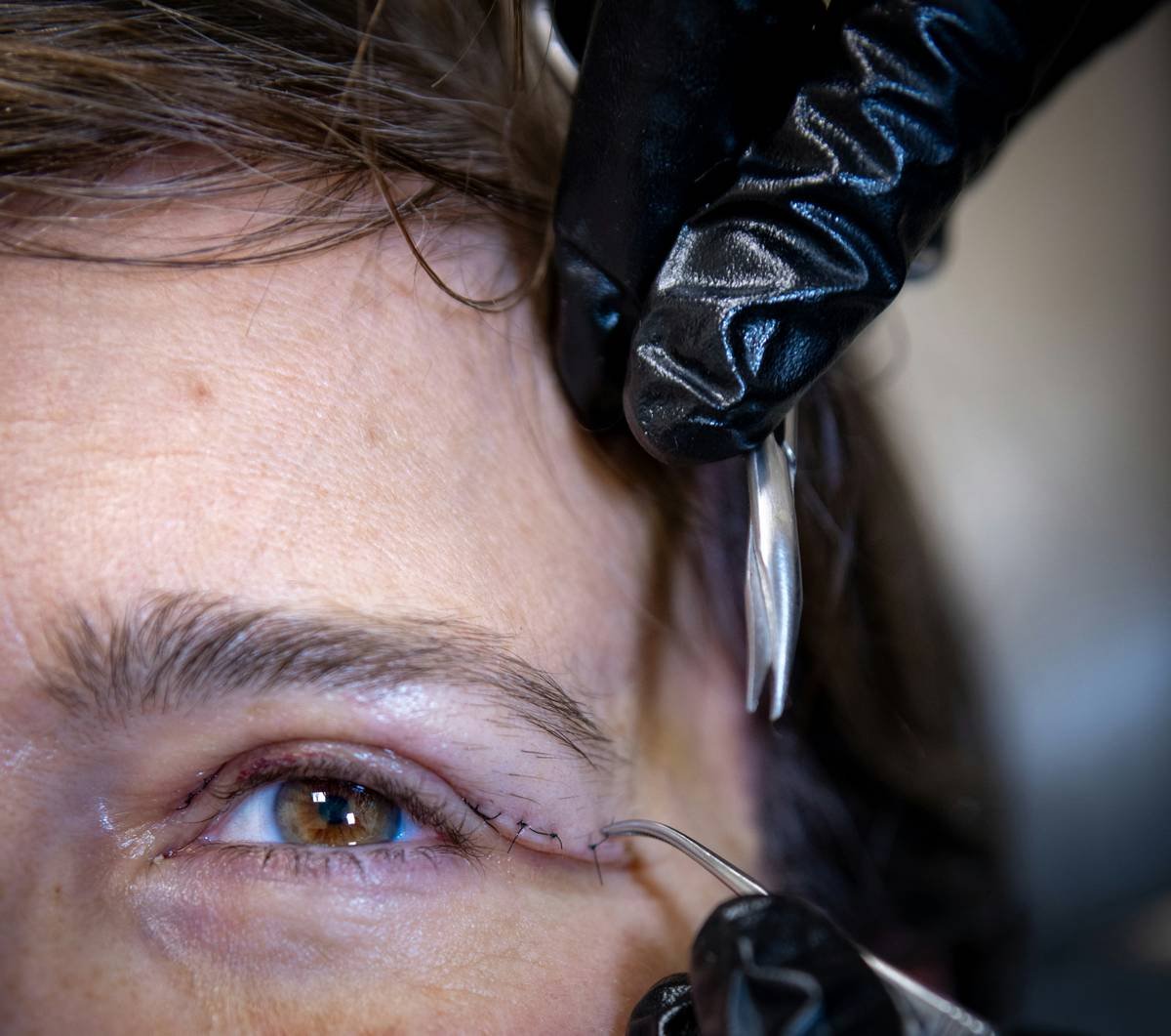 Woman using a heated lash lifting curler for natural-looking curled lashes